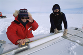 Woman scientist measuring an ice core, drilling on the polar plateau. Antarctica