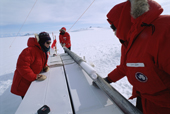 Woman scientist with an ice core, and core in drill. drilling on the polar plateau. Antarctica