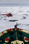 passengers in the bows of a Russian Icebreaker, Kapitan Dranitsyn, with Helicopter. Antarctica.