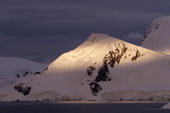 Shaft of early morning light falls on Brabant Is in Gerlache Strait. Antarctic Peninsula.