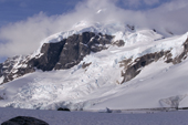 Glaciers tumble from the mountains on Ronge Island, seen from Cuverville Is. Antarctic Peninsula.