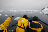 Zodiac cruising with a camera amongst the icebergs by the Whittle Peninsula, Antarctica