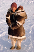 Leah, an Inuit woman, carries her baby in an Amaut (hooded parka) on her back. Igloolik, Nunavut, Canada. 1987