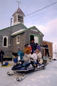 Inuit congregation leaves the Anglican church after Sunday Service in Igloolik. Nunavut. Canada. 1995