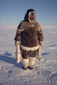 Nutarariaq, an Inuit hunter, with his catch of Arctic Char and Lake Trout. Igloolik, Nunavut, Canada. 1990