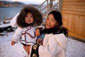 Haunaq Mikkigak, an Inuit woman from Cape Dorset holding her step daughter. Baffin Is., Nunavut, Canada. 2002