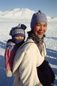 A young Inuit woman carrying her baby in an Amautik. Arctic Bay, Baffin Island, Nunavut, Canada. 2005