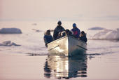 A group of Inuit out walrus hunting in a freighter canoe near Igloolik. Nunavut, Canada. 1992