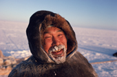 Tatigat, an Inuit hunter, his breath frozen into his beard and caribou skin clothes. Igloolik, Nunavut, Canada. 1993