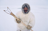 Aipilik, an Inuit hunter in fox furs with Kakivak (Inuit fish spear). Igloolik, Nunavut, Canada. (1993)