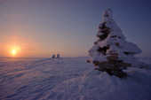 Inukshuk at sunset. These stone figures built by early Inuit hunters were used to drive caribou. Nunavut, Canada. 1999