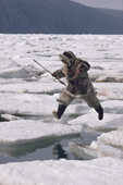 Inuit hunter, Kavavow Kiguktak, jumps from one ice floe to another. Ellesmere Is., Nunavut, Canada. 1994
