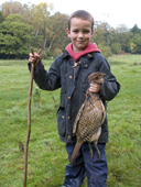 7 year old Drew helps with the beating on a pheasant shoot in Hampshire. England