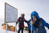 2009 Monaco Antarctic Expedition celebrate by air-kissing the marker placed by the US Amundsen-Scott station overwintering team at the Geographic South Pole, beside the plaque to Scott and Amundsen.