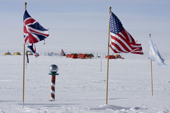 Ceremonial South Pole, Flags of Nations and visitors to the Pole in tents. Antarctica