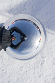 David Rootes reflected in the globe at the Ceremonial South Pole. Amundsen-Scott Station. Antarctica