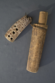 A Nenets reindeer herder's traditional knife with a wooden handle & sheath. It is attached to a traditional tool holder made of mammoth ivory. Gyda, Gydan Peninsula, Yamal, Siberia, Russia
