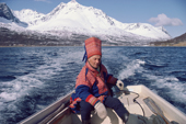 Sami reindeer herder, Aslak Logje, takes his boat to summer pastures on an island. North Norway. 1985