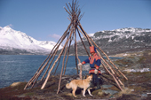 Sami reindeer herder, Aslak, by the frame of his tent / lavvu by summer pastures. North Norway. 1985