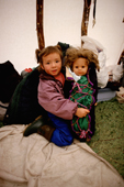 Innu girl with her doll dressed in a traditional baby binding. Labrador. Canada. 1997