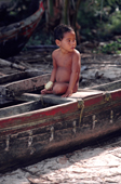 Young Yapese boy sitting on a traditional canoe. Ifalik Atoll, Yap, Caroline Islands, Micronesia. 1996