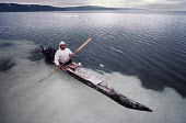 Qulutanguaq, an Inuit hunter uses a sealskin Kayak to hunt Narwhal in the summer. Inglefield Bredning, Northwest Greenland. (1980)