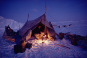 An Inuit hunter, Ituko, lights two Primus stoves to warm his tent. N.W. Greenland. 1986