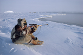 An Inuit hunter, Jens Danielsen, shoots at a seal from the floe edge near Cape York. N.W. Greenland. 1986