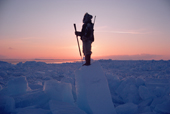 Jens, an Inuit hunter scans the ice of Melville Bay for polar bears. Northwest Greenland. (1986)