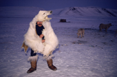 Ituko, an Inuit hunter imitates a polar bear to train his dogs. N.W. Greenland. 1987