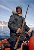 Kale Hendriksen, An Inuit hunter, steers his boat during a walrus hunt in Smith Sound. Northwest Greenland. (1989)