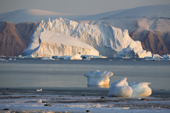 A large Iceberg floating in Inglefield Bay with small pieces of glacial ice on the shoreline. Northwest Greenland. 2008