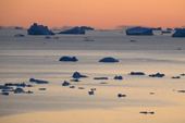 Icebergs and small pieces of glacial ice floating in Inglefield Bay at sunset. Northwest Greenland. 2008