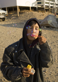 Abel, an Inuit boy, plays at blowing bubbles outside the shop in Qaanaaq. Northwest Greenland. 2008