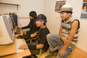 Young Inuit playing computer games at the Youth Club in Qaanaaq. Northwest Greenland. 2008