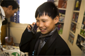 Abel Sadorana, an Inuit boy from Qaanaaq, uses the mobile phone he has been given for his eleventh birthday. Northwest Greenland. 2008