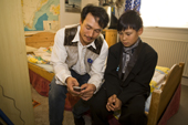 Avigiaq Sadorana, an Inuk from Qaanaaq, shows his son Abel hot to use the mobile phone he has been given for his eleventh birthday. Northwest Greenland. 2008