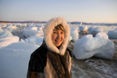 Sofie Jensen, a young Inuit woman, dressed in traditional sealskin jacket with fox fur ruff. Qaanaaq, Northwest Greenland. 2008