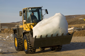 A front loader being used to collect glacial ice to be used for community's water supply in Qaanaaq. Northwest Greenland. 2008