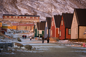 Inuit walking along one of the streets in Qaanaaq at Sunset. Northwest Greenland. 2008