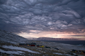 Dramatic Asperatus cloud formation as a storm builds at dawn over Qaanaaq, Inglefield Bay. Northwest Greenland. 2008