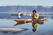 Inuit hunter, Qitdlak Duneq, in his sealskin kayak amongst summer ice near Qeqertat, Inglefield Bredening, Thule, Avanersuaq. Northwest Greenland. (1977)