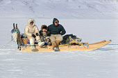 Ilanugaq Kristiansen & his partner, Aviaq, travelling by dog sled with their daughter, Tukumeq, in the Spring near the village of Siorapaluk. Avanersuaq, Northwest Greenland. (1977)