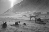 Storm in the Inuit village of Siorapaluk, blows snow around the sleds and houses. Thule, Northwest Greenland. 1977