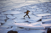Inuit child on broken sea ice in the autumn. Savissivik, N.W. Greenland. 1991