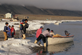 Inuit family prepare to go to a summer camp by boat. Moriussaq, N.W. Greenland. 1997