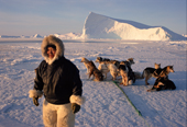 Inuit hunter,Qaerngak Nielsen, with his dog team out seal hunting near Cape York. N.W. Greenland. 1998