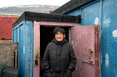 Saufak Kiviok, an elderly Inuit woman, outside her home in the community of Qaanaaq. Avanersuaq, Northwest Greenland