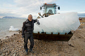 Magssanguak Imina, an Inuit man, collecting glacial ice, with a front loader, that will be used for the community's water supply in Qaanaaq. Avanersuaq, Northwest Greenland