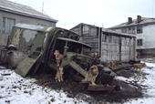 Sled dogs tethered to an old truck in Uelen. Chukotka, Siberia, Russia. 2004